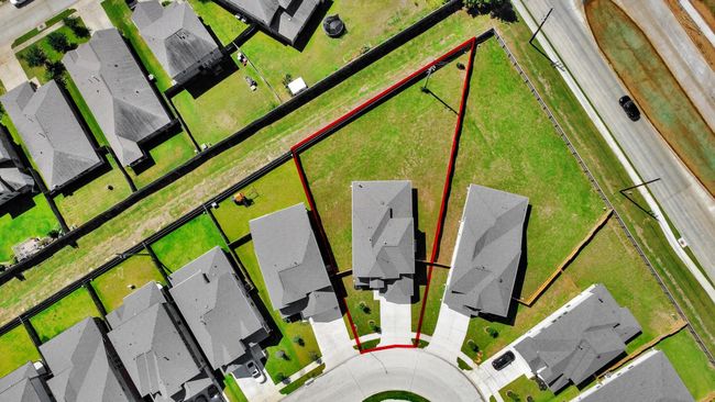 An aerial view of a spacious subdivision lot, highlighting a well-maintained yard and a fully fenced perimeter, offering both privacy and expansive outdoor space. | Image 4