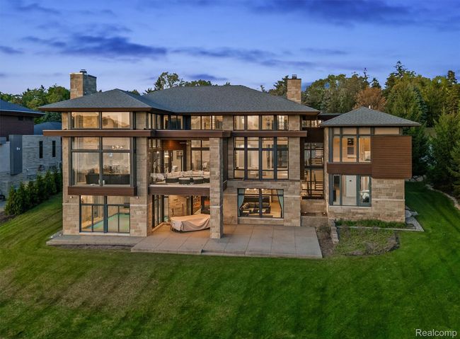 Rear view of property with a chimney, a lawn, and a balcony | Image 36