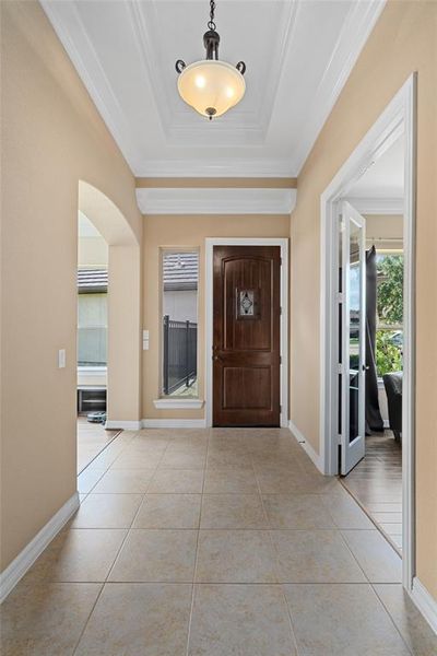 Welcome to an inviting foyer accentuated by elegant tile floors, soaring ceilings, and a flood of natural light for an immediate sense of home. | Image 3