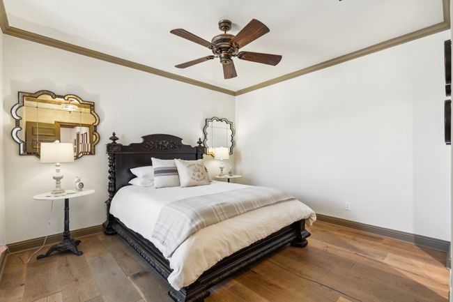 Secondary Bedrooms Feature Wood Plank Flooring and Walk-In Closets | Image 26
