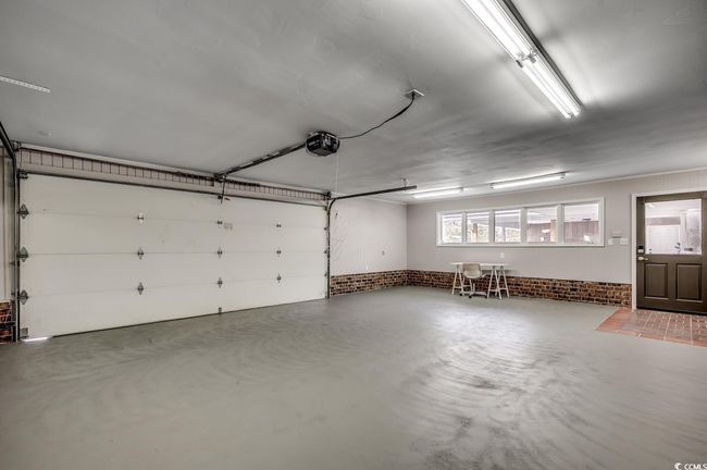 Garage with a garage door opener | Image 30