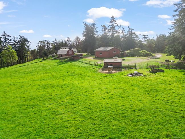 View of yard featuring a barn and an outbuilding | Image 58