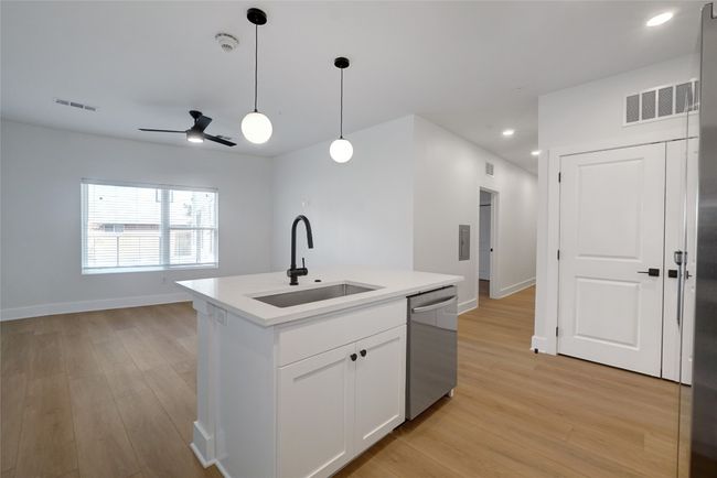 Kitchen featuring a sink, dishwasher, light wood-style floors, a ceiling fan, and recessed lighting | Image 6