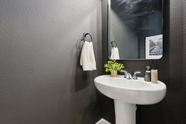 Bathroom with a textured wall and a sink | Image 31