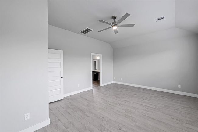 Primary bedroom with vaulted ceilings. | Image 20