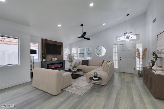 *Virtually Staged*Living area featuring light wood-type flooring, a healthy amount of sunlight, and a fireplace | Image 10