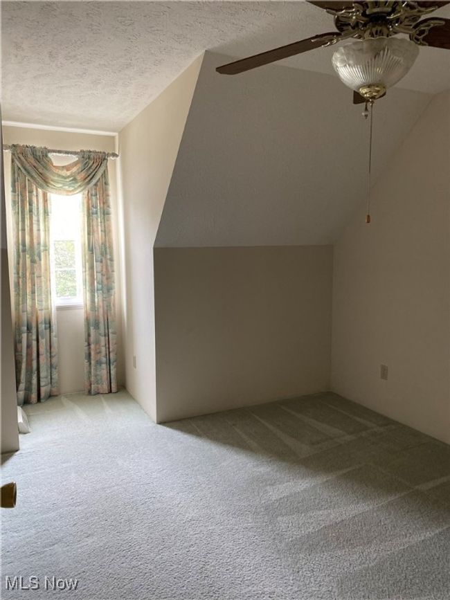 Bonus room with carpet, ceiling fan, a textured ceiling, and lofted ceiling | Image 14