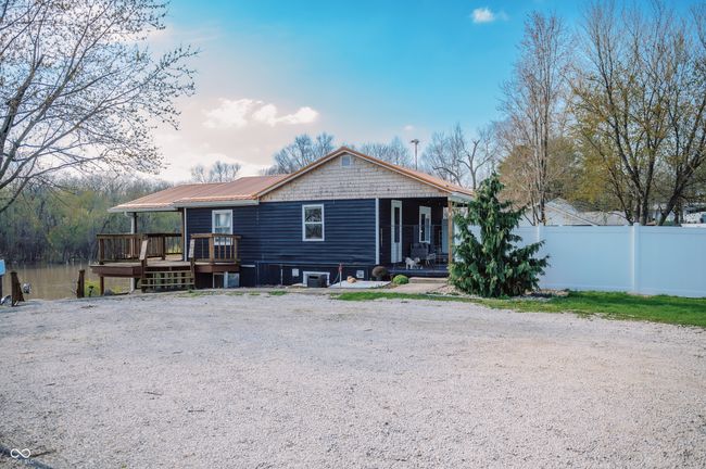 view of front of home featuring metal roof and fence | Image 7