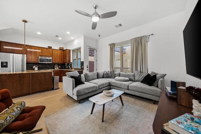 Living room featuring recessed lighting, lofted ceiling, visible vents, light wood-style floors, and ceiling fan | Image 11