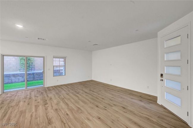 Unfurnished room with light wood-style floors, recessed lighting, visible vents, and baseboards | Image 7
