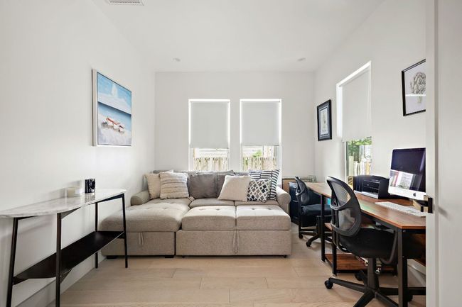 Home office featuring light wood-type flooring and visible vents | Image 14