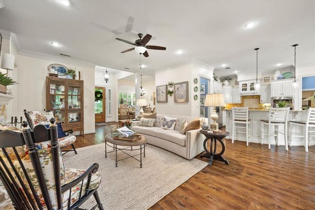 Living room with hardwood / wood-style floors, ceiling fan, and crown molding | Image 16