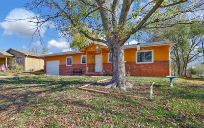 Single story home with a garage and a front lawn | Image 2