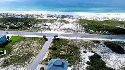 Birds eye view of property with a beach view | Image 1