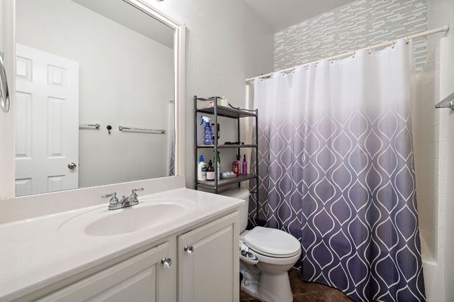 Bathroom with vanity, bidet & toilet, tile patterned floors, and shower / bath combo | Image 22