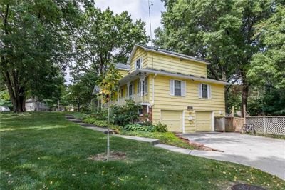 View of front facade featuring a front lawn and a garage | Image 2