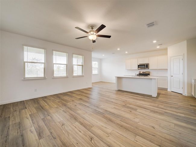 Unfurnished living room featuring a ceiling fan, light wood-style floors, recessed lighting, and baseboards | Image 8
