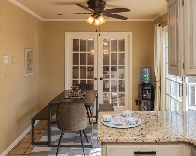 Dining space featuring french doors, baseboards, ceiling fan, and crown molding | Image 12