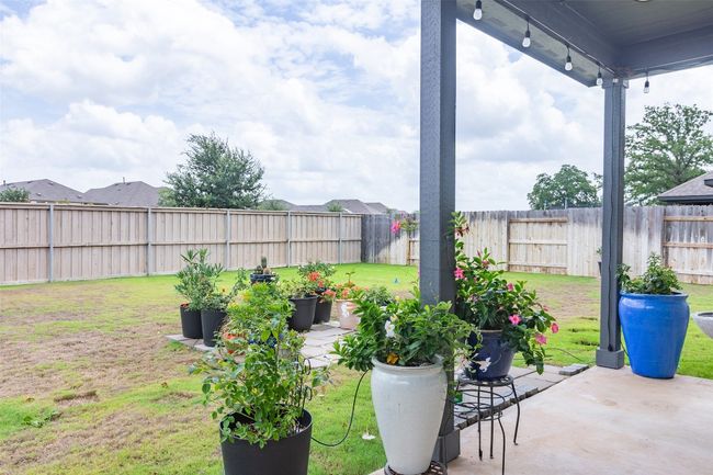 Fenced backyard with a patio | Image 31