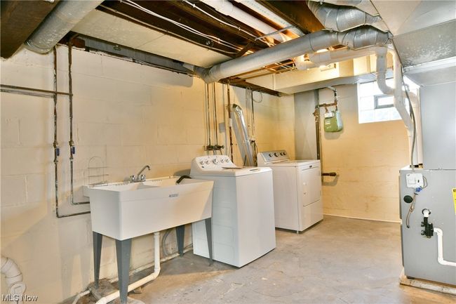 Laundry area with washer hookup, washing machine and dryer, and sink | Image 31