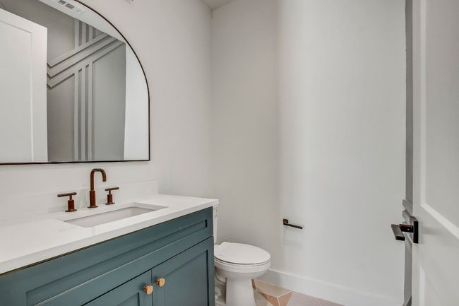 Half bathroom with vanity, toilet, and tile patterned flooring | Image 15