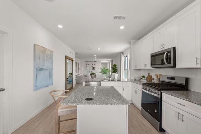 Photo of Pulte model home with same floor plan, not of actual home listed. | Image 5