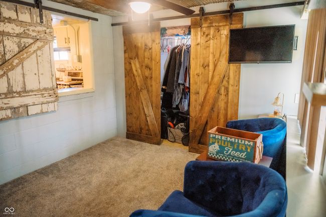 basement with carpet flooring and a barn door | Image 16
