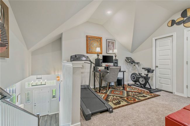 Workout area with lofted ceiling and carpet flooring | Image 15