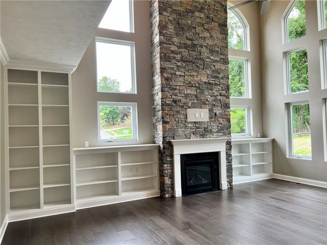 2 story family room with stacked stone fireplace | Image 6