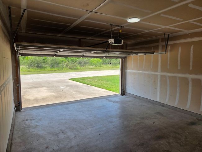 Garage featuring a garage door opener | Image 7