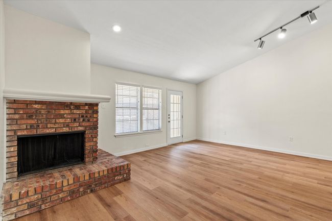 Freshly painted living room has plenty of sunlight coming in from the windows. | Image 9