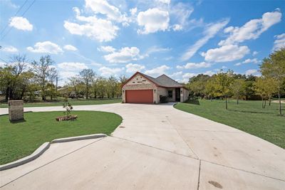 View of front of house featuring a garage and a front yard | Image 3