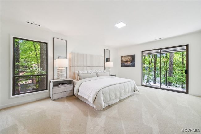 Carpeted bedroom featuring access to exterior and visible vents | Image 34