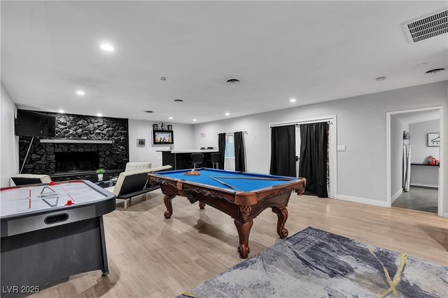 Playroom featuring visible vents, light wood-type flooring, recessed lighting, pool table, and a stone fireplace | Image 16