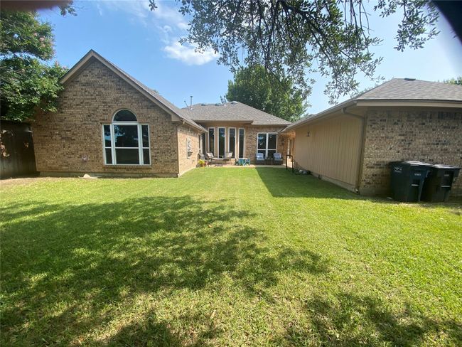 Rear view of house featuring a yard, brick siding, and a patio area | Image 29