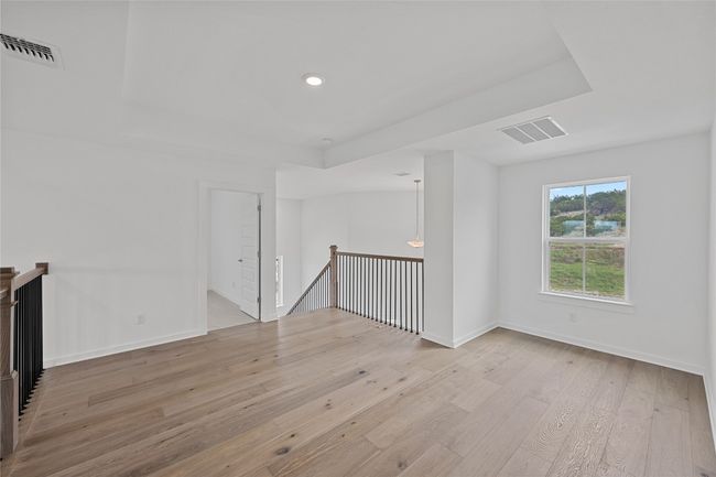 Unfurnished room with light wood-style flooring, a raised ceiling, baseboards, and recessed lighting | Image 21