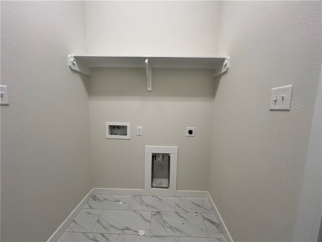Washroom with hookup for an electric dryer, light marble finish flooring, and washer hookup | Image 15