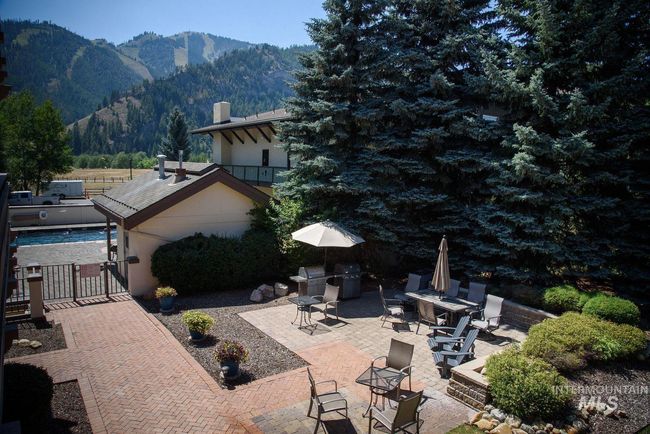 View of patio / terrace with a mountain view, a gate, and area for grilling | Image 15