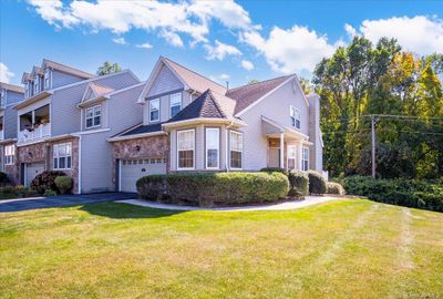 View of front facade featuring a front yard and a garage | Image 1