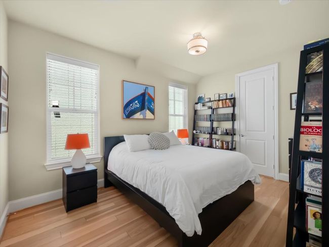 Bedroom with light wood-style floors and baseboards | Image 14