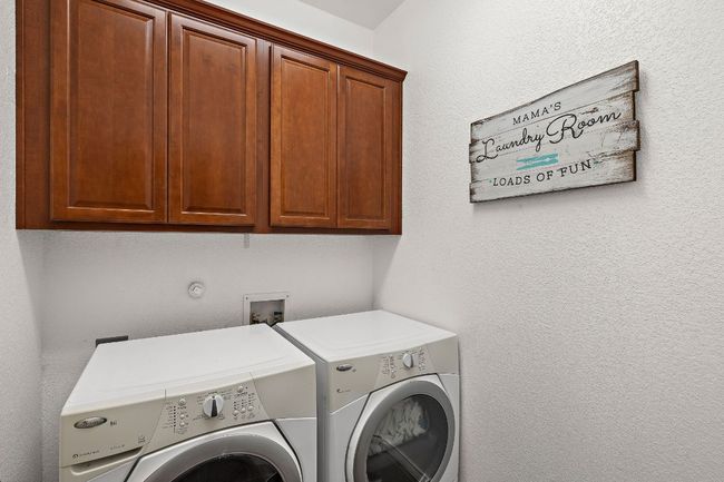 Laundry room featuring cabinet space and washer and clothes dryer | Image 27
