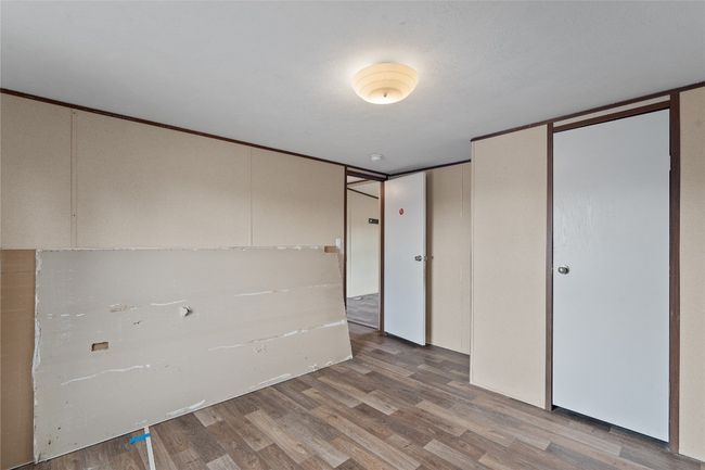 Unfurnished bedroom with wood finished floors | Image 26