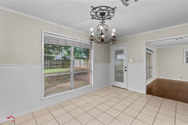 Unfurnished dining area featuring ornamental molding, a chandelier, and wainscoting | Image 8