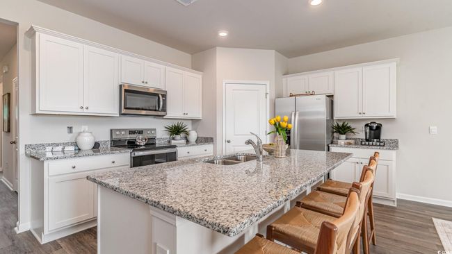Kitchen featuring appliances with stainless steel finishes, a sink, dark wood-style flooring, baseboards, and recessed lighting | Image 9