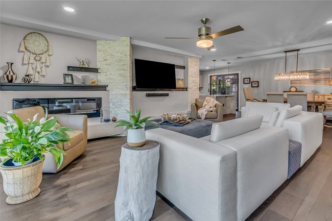 Living area with a ceiling fan, wood finished floors, and recessed lighting | Image 9