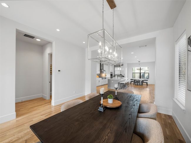 Dining room featuring light wood-type flooring, a chandelier, and recessed lighting | Image 11
