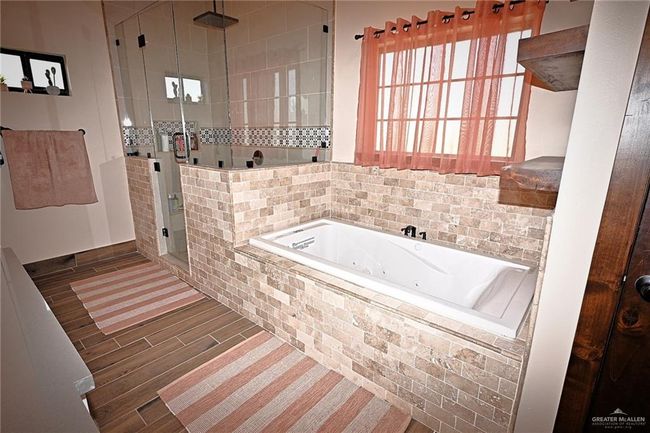 Bathroom featuring shower with separate bathtub | Image 14