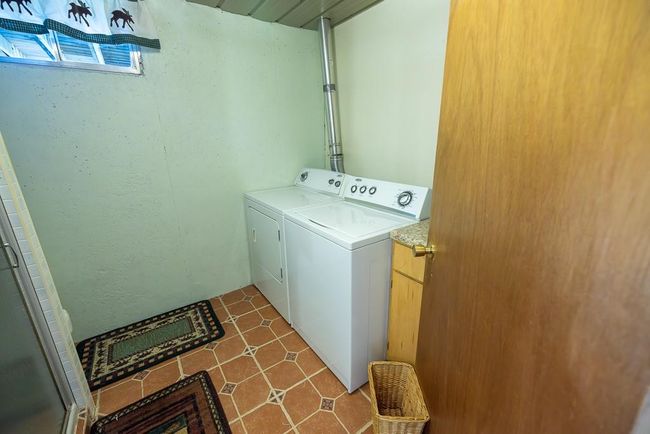 Clothes washing area with washer and clothes dryer | Image 22