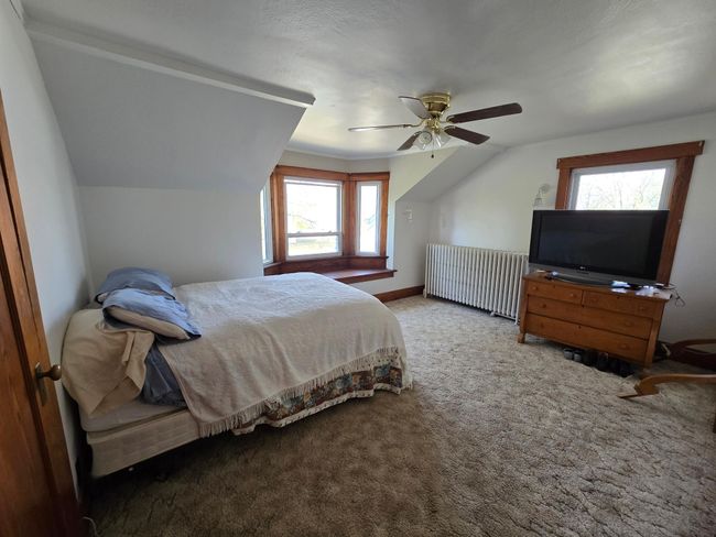 Carpeted with ceiling fan & closet | Image 32