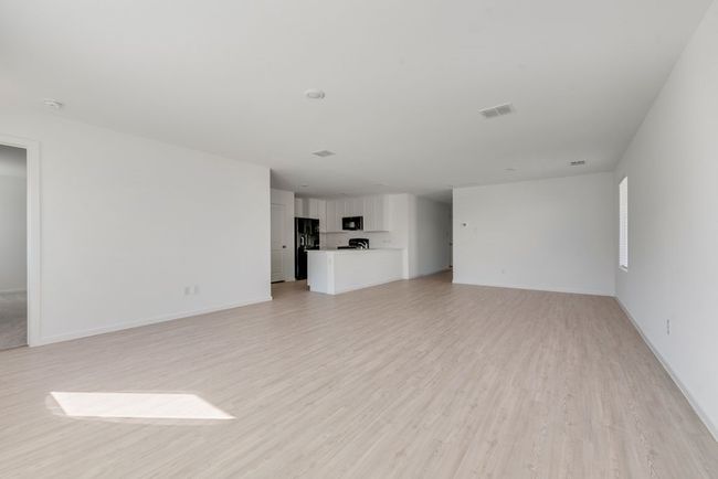 Unfurnished living room with light wood-type flooring and baseboards | Image 8